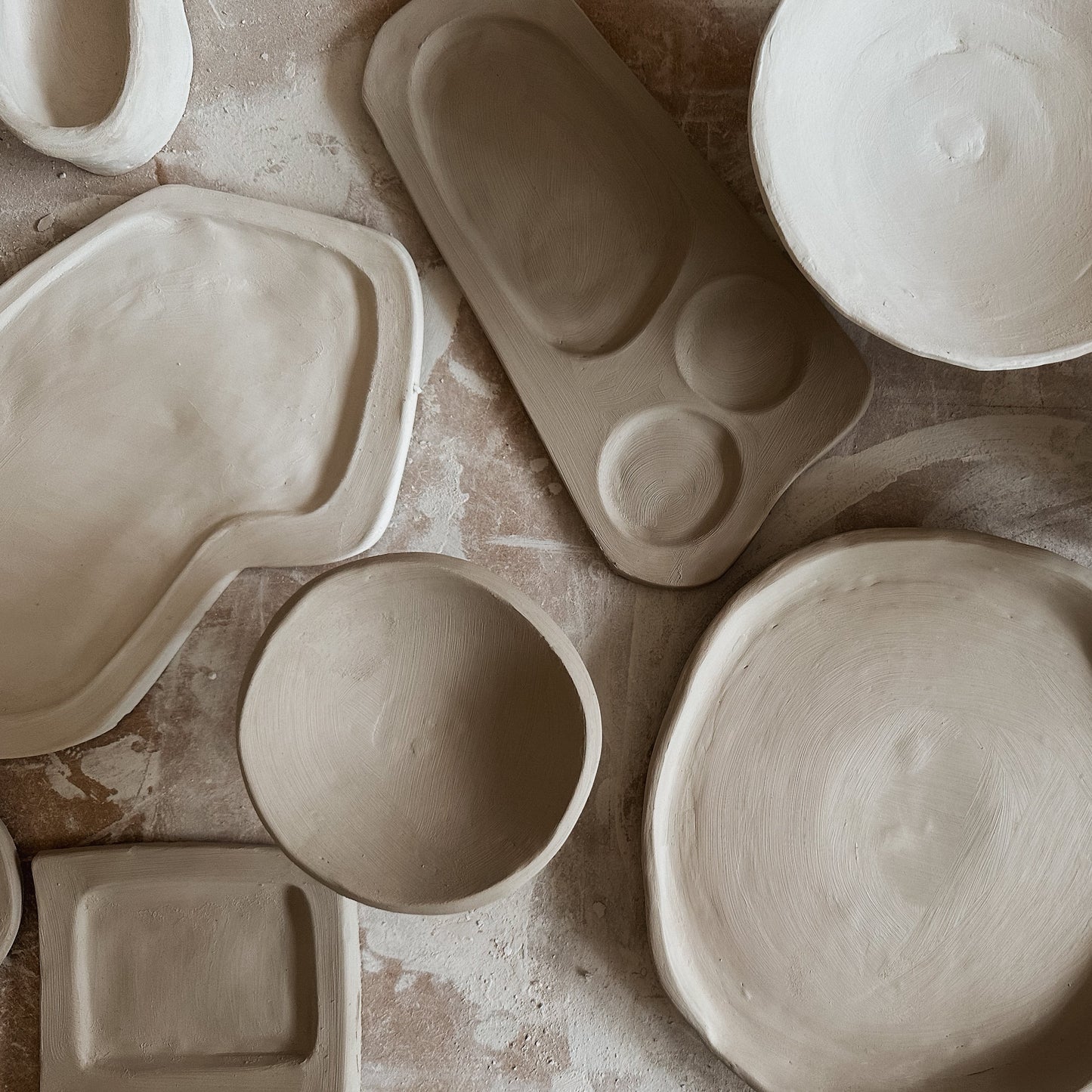 Collection of ceramic molds on a textured surface