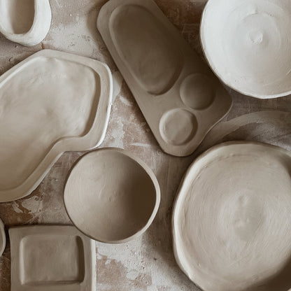 Collection of ceramic molds on a textured surface